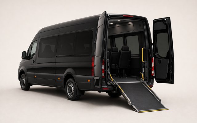Black wheelchair accessible minibus with deployed ramp